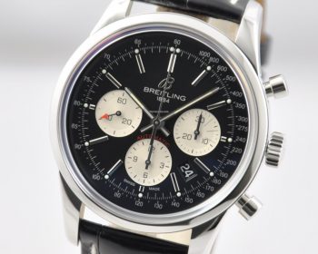 The black dial fake watch has a black strap.